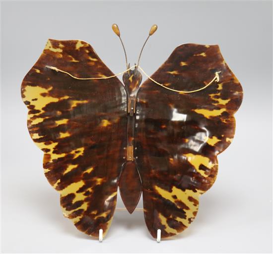 A tortoiseshell wall ornament in the form of a butterfly with folding wings approx 25 x 26cm
